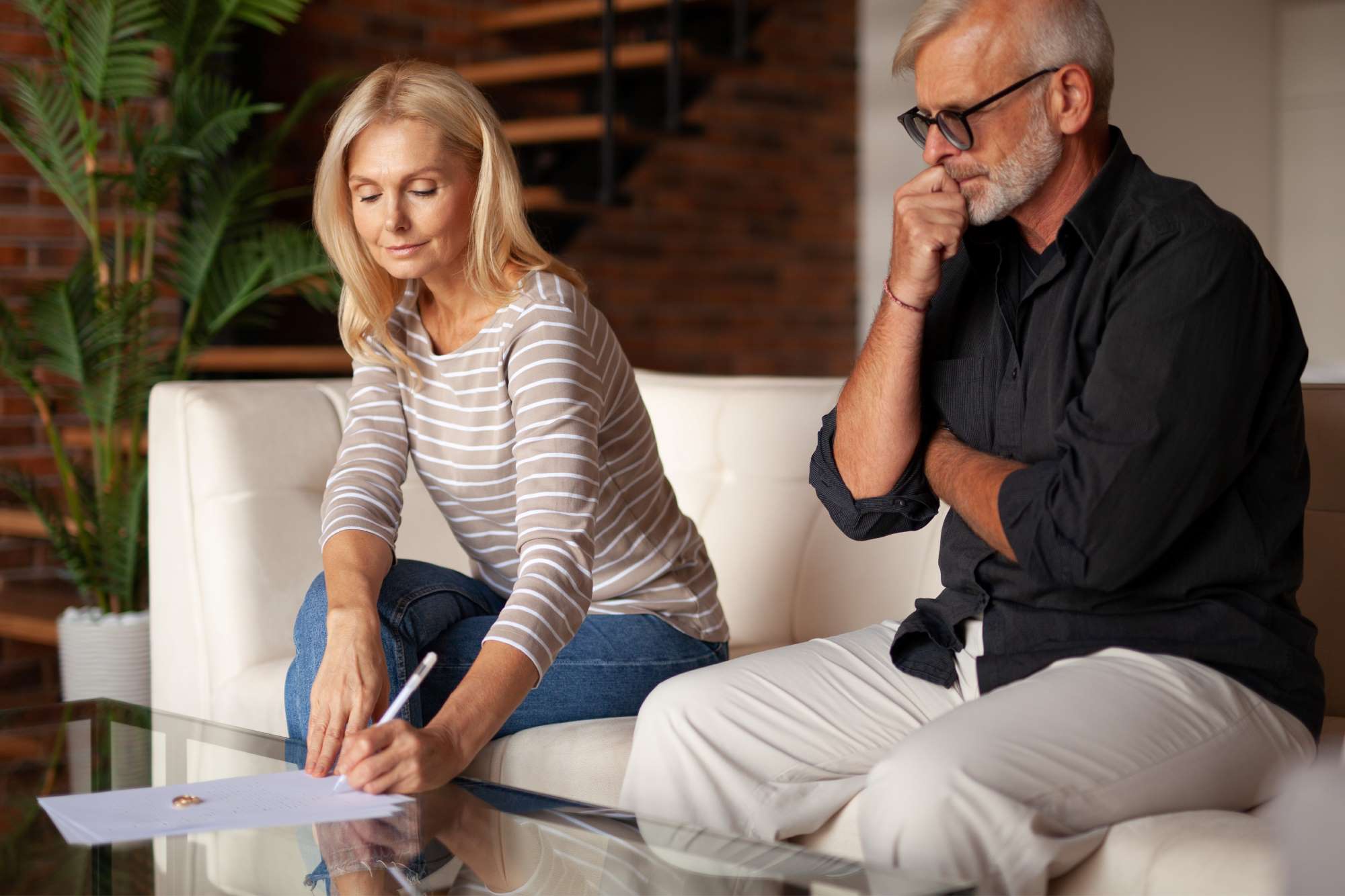 an over-50 couple reviewing documents for a gray divorce